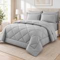 Light grey 7-piece comforter set with sheets styled on a complete queen bed