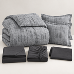 Folded charcoal grey 7-piece comforter set with sheets, pillowcases and shams