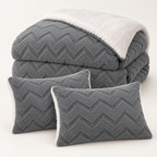 Grey three-piece sherpa comforter set with one comforter and two matching pillowcases